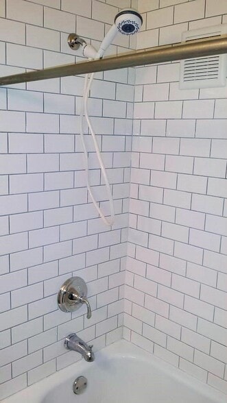 Subway tile shower with bath fan and flexible shower head - 2119 N 11th St