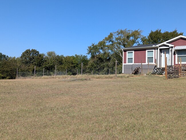 look to the left of the house to see a gated area for dogs - 179 Davis Rd