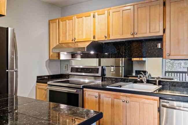 Building Photo - $500 off! Spacious 1-bdrm/1-bath condo in quiet neighborhood. Balcony, 2 parking spaces, fireplac...