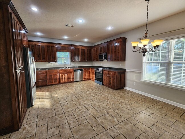 Building Photo - !!$500!! OFF FIRST MONTH!! Spacious 4BR Home with Fireplace, Screened Porch & Privacy-Fenced Yard