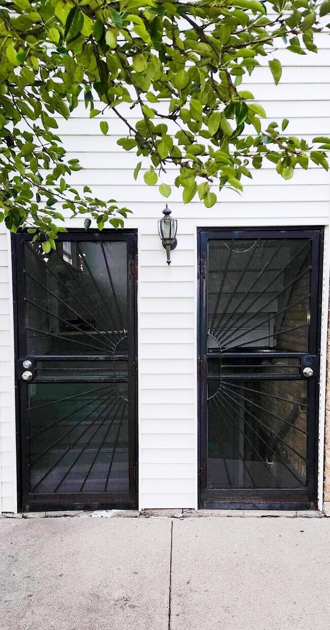 Heavy duty back storm doors - 6042 W Miami Ave