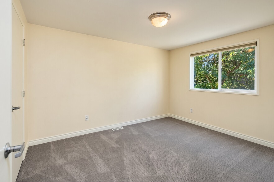 Back master bedroom offers walk-in closet and garden views. - 7051 8th Ave NW
