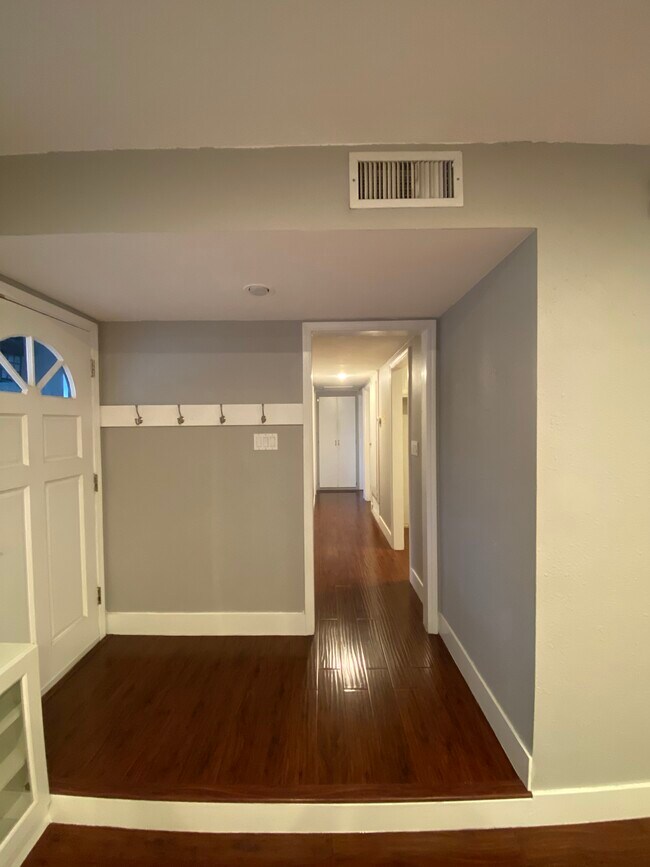 Front door and Hallway to bedrooms - 8561 Cedar Dr