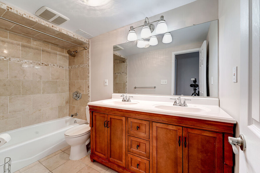 Full bathroom with marble tile flr and walls & double vanity! - 4242 East West Hwy