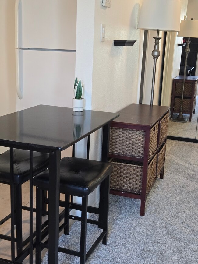 View into kitchen and bedroom area. Dining table and dresser. - 7649 Beckett St