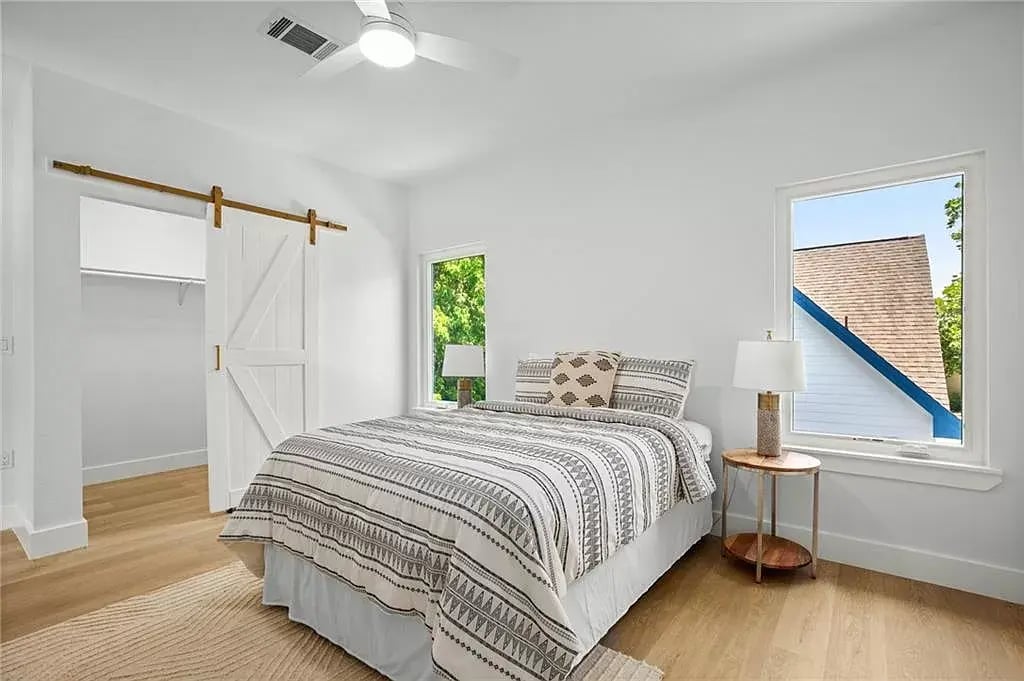 Walk in closet featuring barn doors. - 5402 Duval St