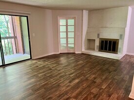 Living room with fireplace, private deck and home office behind French doors - 117 Turtle Creek Rd