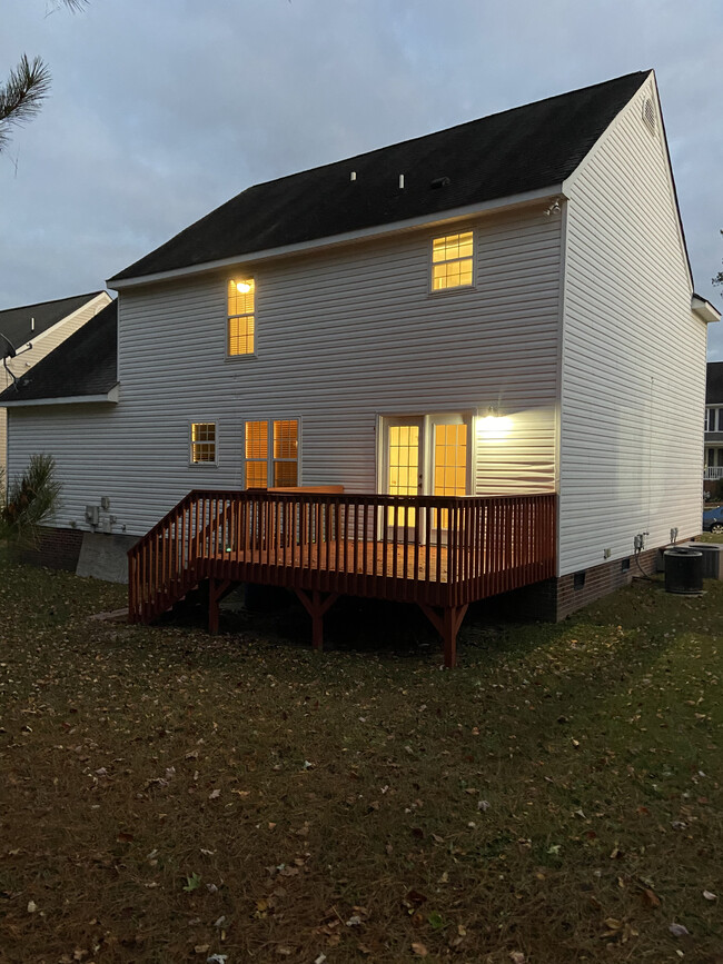 Twilight rear view of house and deck - 1309 Ujamaa Dr