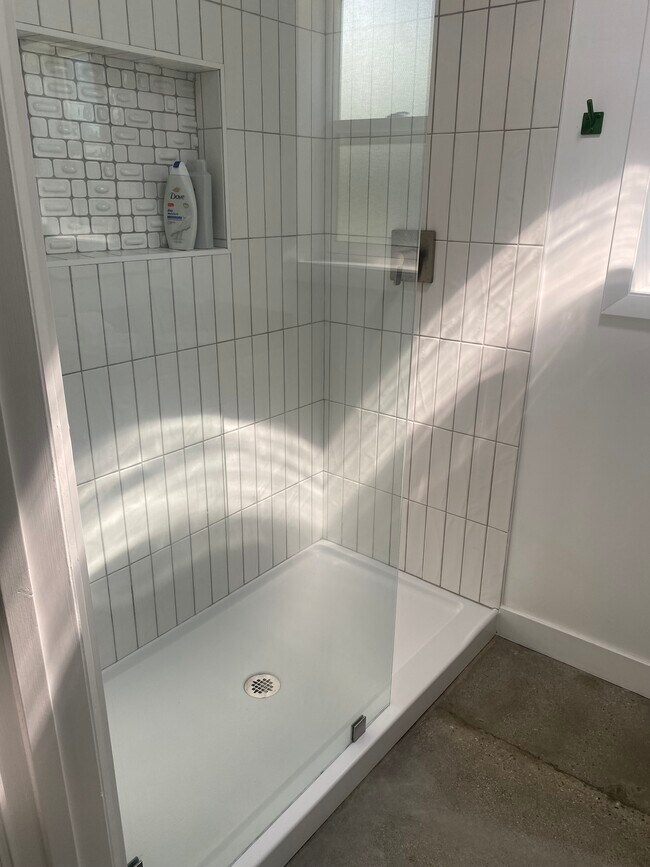 Brand new custom tiled step in spacios shower with overhead waterfall fixture - 1037 Keniston Ave