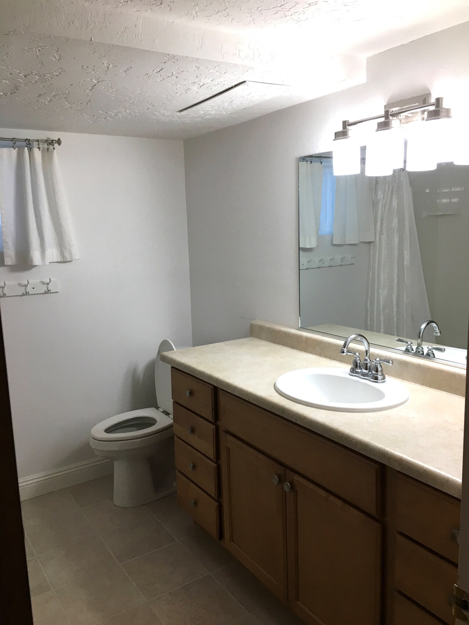 Bathroom Counter, sink, mirror and toilet - 5509 W 13600 N