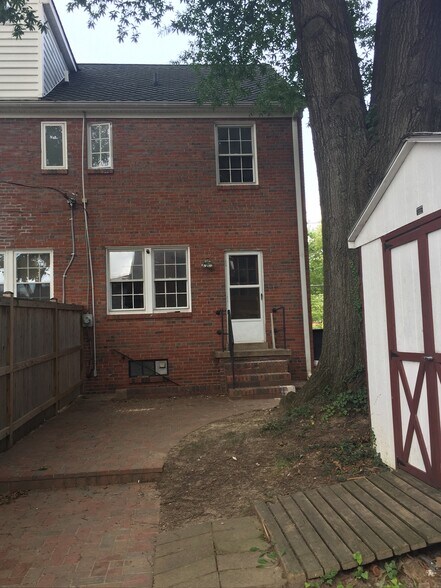 Backyard featuring brick patio and shade tree - 836 20th St S