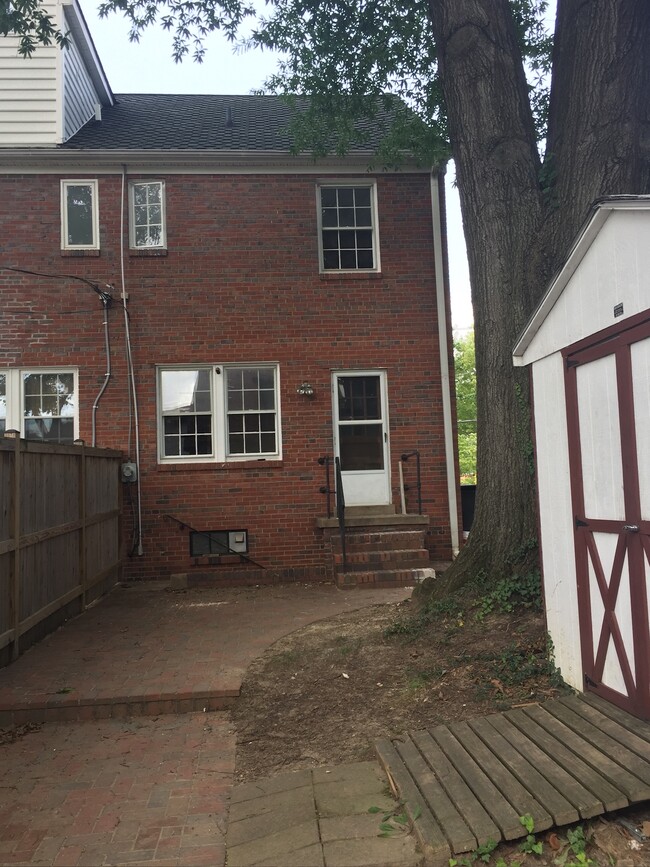 Backyard featuring brick patio and shade tree - 836 20th St S