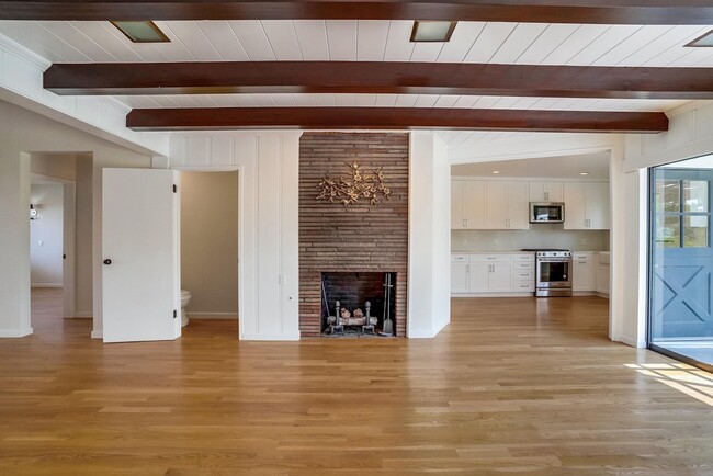 Original Fireplace restored next to open kitchen - 556 Luton Dr