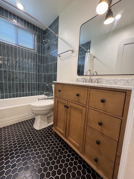 Refurbished bathroom with custom floor tile - 1016 Western Ave