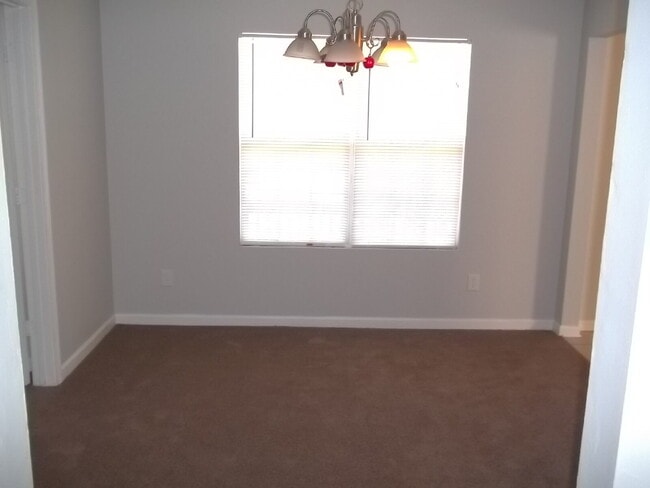 Building Photo - Freshly painted and new flooring in this 4 Bedroom 2 and Half Bath home. Covered front porch with...