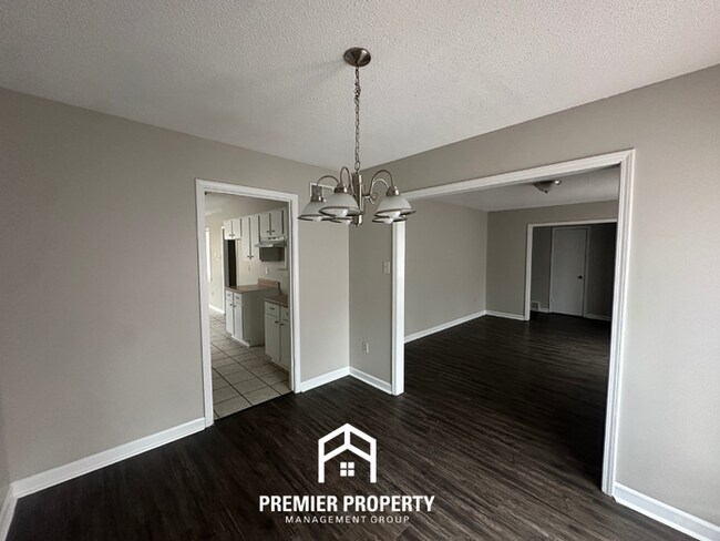 Building Photo - Charming 3BR Memphis Home | Rustic Brick Fireplace, Formal Dining & Fenced Backyard