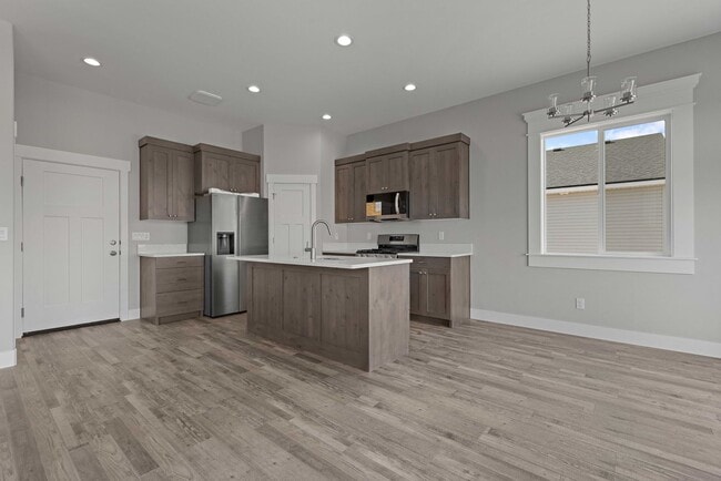 Building Photo - NEW HOME with large garage stalls and unfinished basement for additional storage