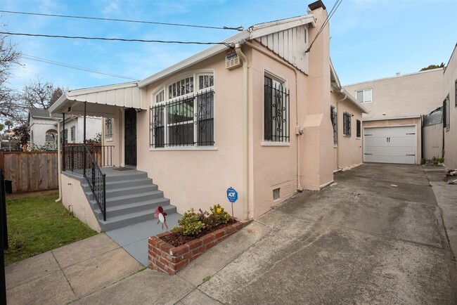 Side view of the property displaying the front yard, lovely stairs leading to the front patio. - 2108 E 23rd St
