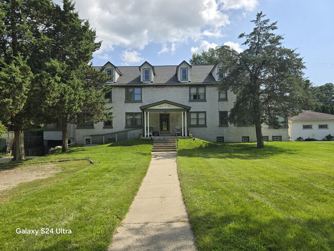 Welcome to your future home! This charming, classic building with a welcoming porch and lush green s - 305 Michigan Ave