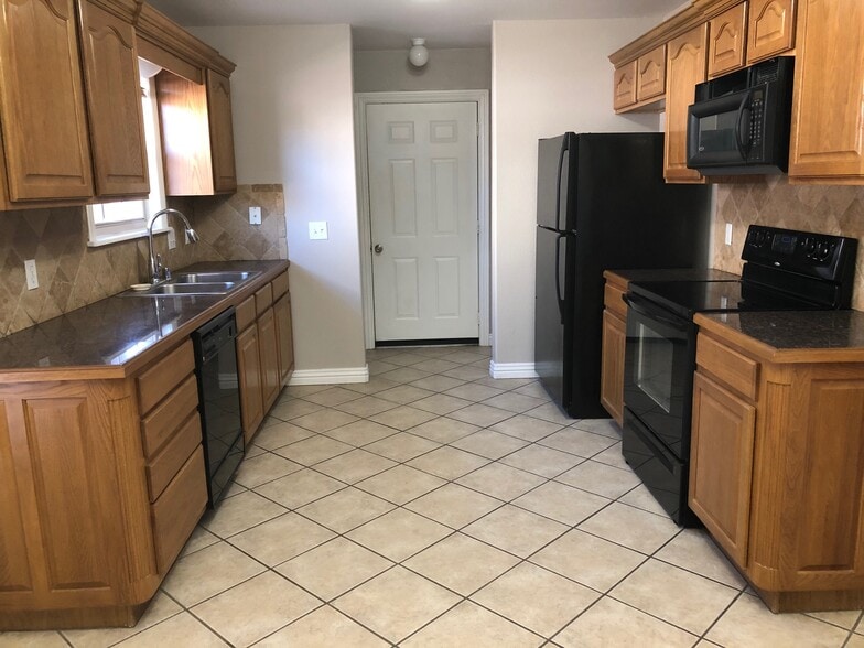 Kitchen view toward garage entry and utility area - 6188 W Milliken Bnd