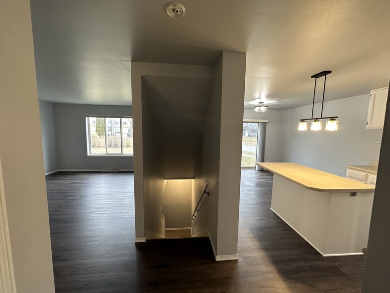 Living room, kitchen and stairs to rec room - 1505 Glacier Hill Dr