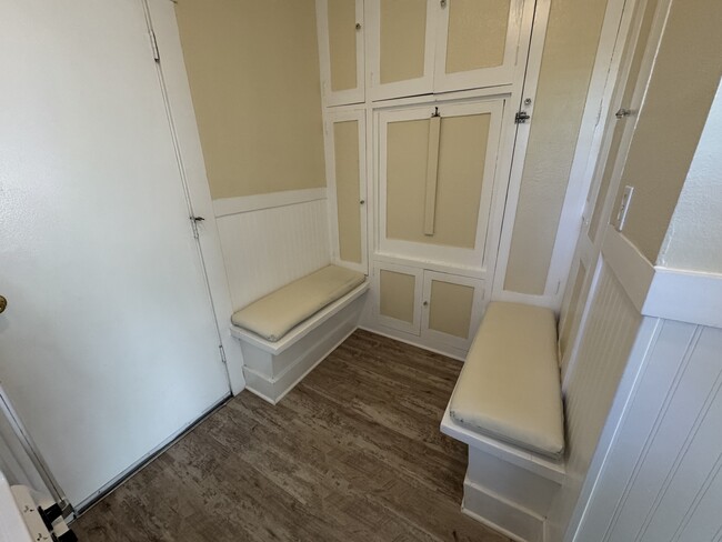 Eat in kitchen with bench seats, cushions and drop down table shown in the upright position. - 1749 E 3rd St