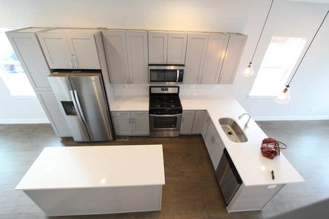 view of kitchen, gas range and oven, ice maker, vented mwave hood - 1919 W 46th Ave