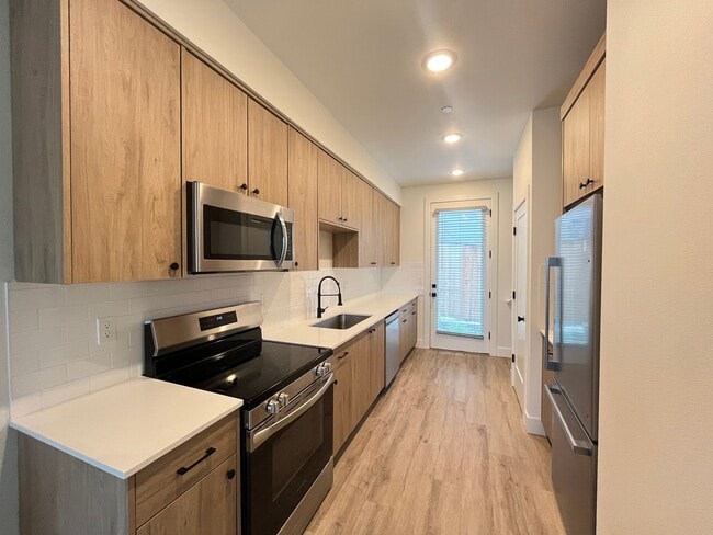 Building Photo - Modern 2-Bed, 1.5-Bath Condo with Custom Kitchen, Private Patio, and Prime Location
