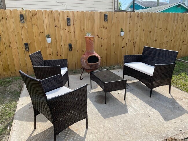 Backyard with privacy fence, chimnea, charcoal grill and solar lights. - 5201 Avenue O 1/2