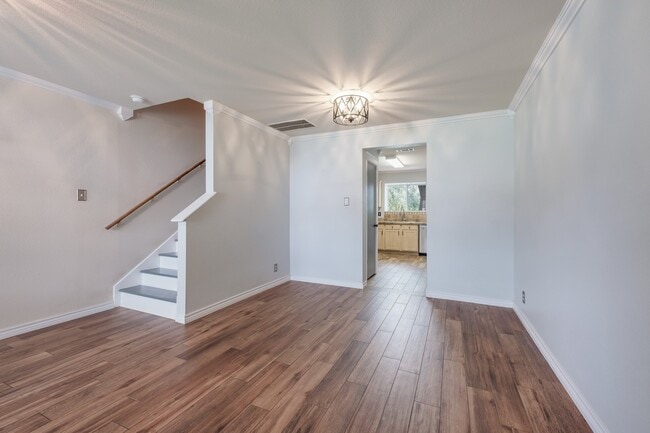 Building Photo - ***APPLICATION CURRENTLY UNDER REVIEW***Modern Elegance: 3-Bedroom Townhome with Wood Flooring, S...
