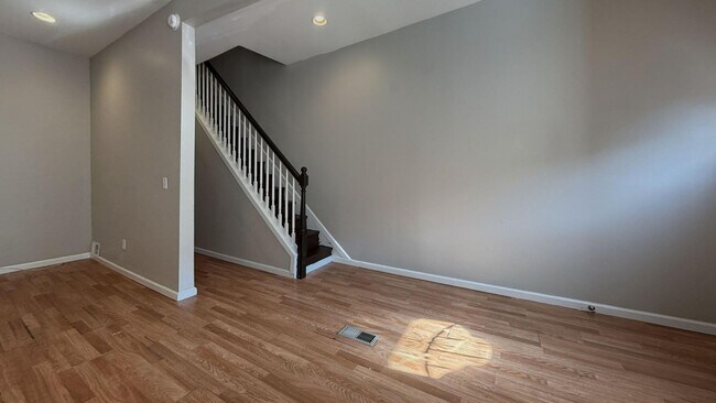 Building Photo - Charming 4BR/2BA Rowhouse with Hardwood-Style Flooring Throughout