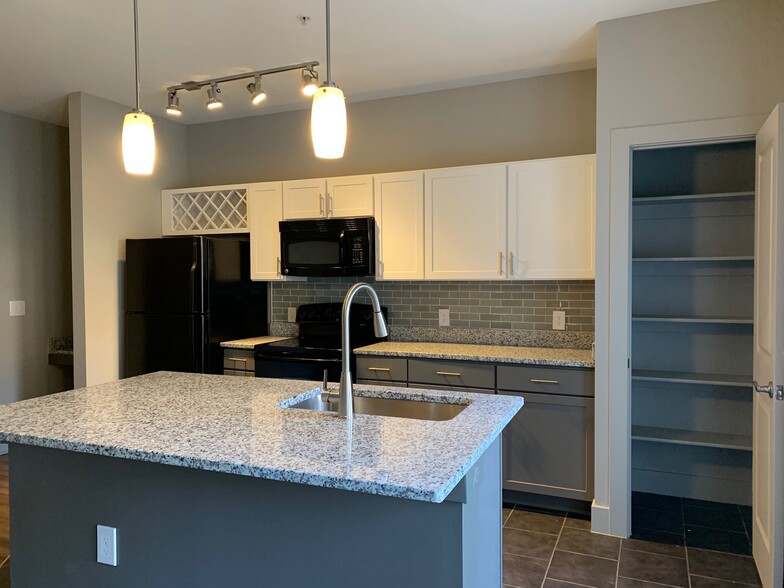 Attico Kitchen Island with Granite Counter Tops - The Lofts at Willow Creek