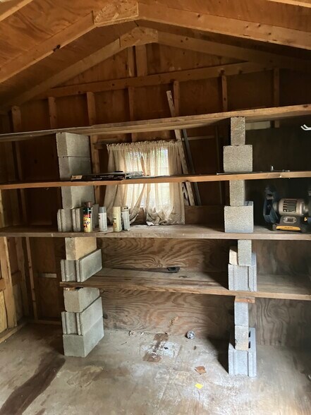 storage shed has shelves and windows - 104 E Poplar St