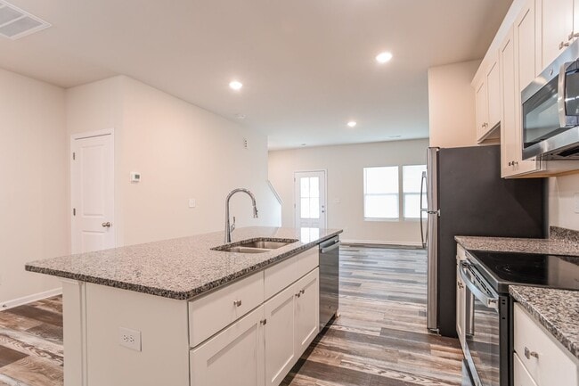 Building Photo - FIRST MONTH FREE - 3BR Townhome • Full Kitchen • Garage + Driveway