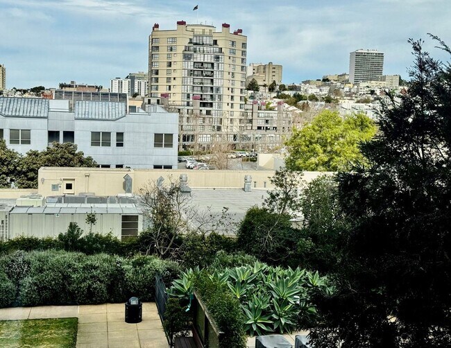 Building Photo - Corner Light. City Energy. Zero Compromise.