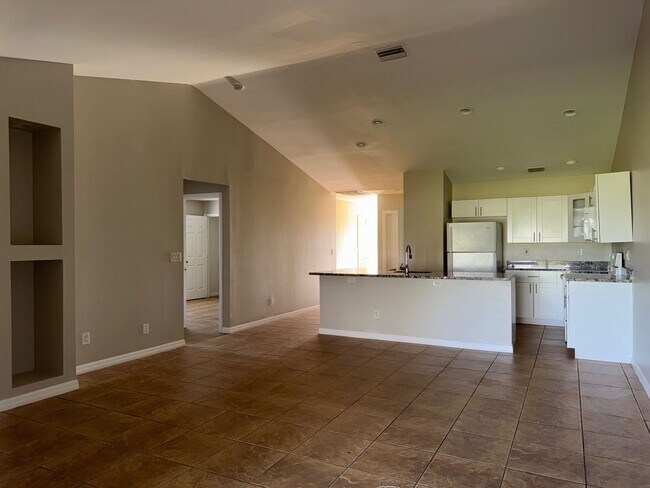 Building Photo - Experience this Cape Coral 3 bedroom 2 bath corner duplex with 1 car garage and screened in lanai.