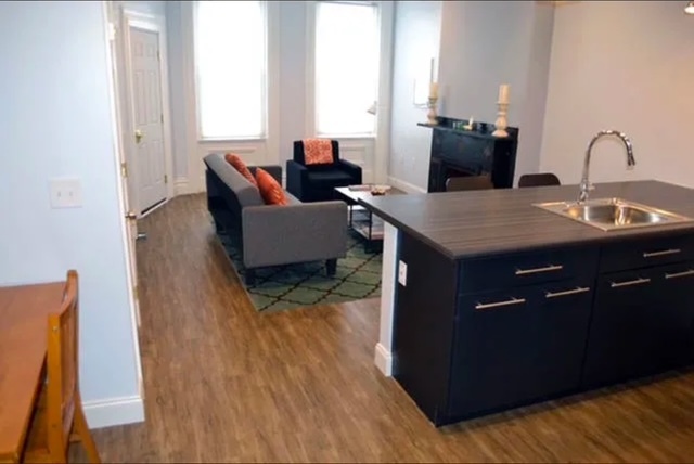 Two large front windows light up the living and dining space. - 1004 Madison Ave