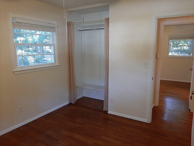 The bedroom has adjustable closet shelving and a ceiling fan. - 2955 Fantasy Ln
