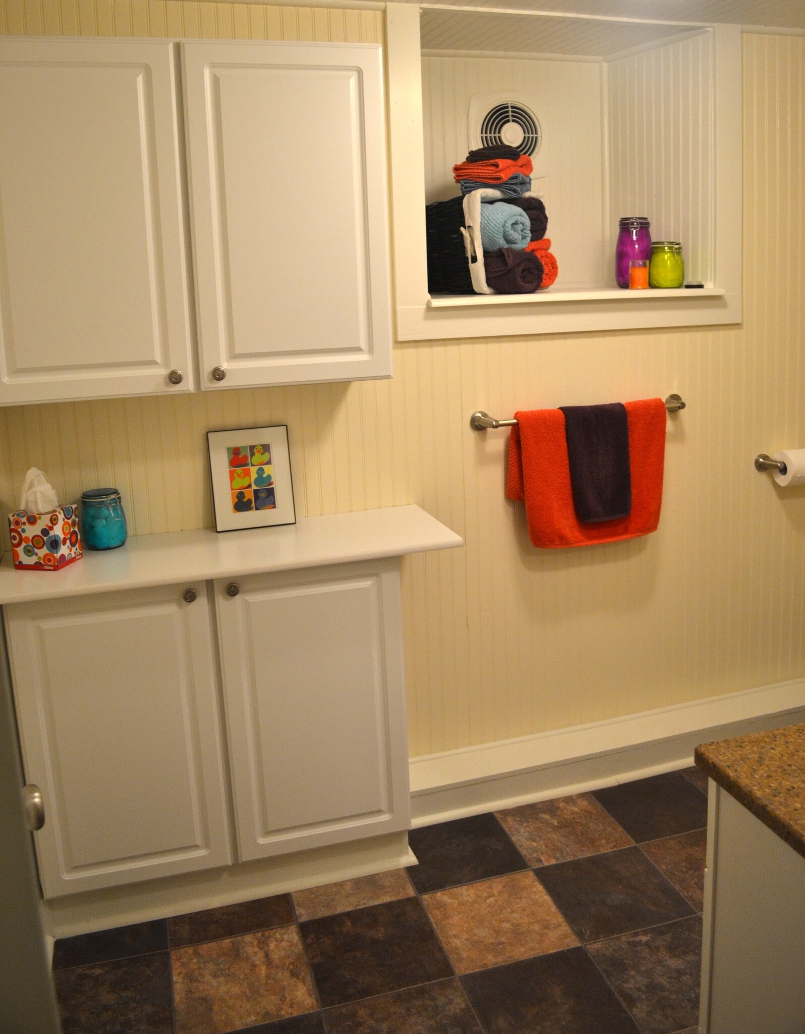 old staging of bathroom: linen cabinets w/ counter, closed up window well houses exhaust fan - 222 W Case St