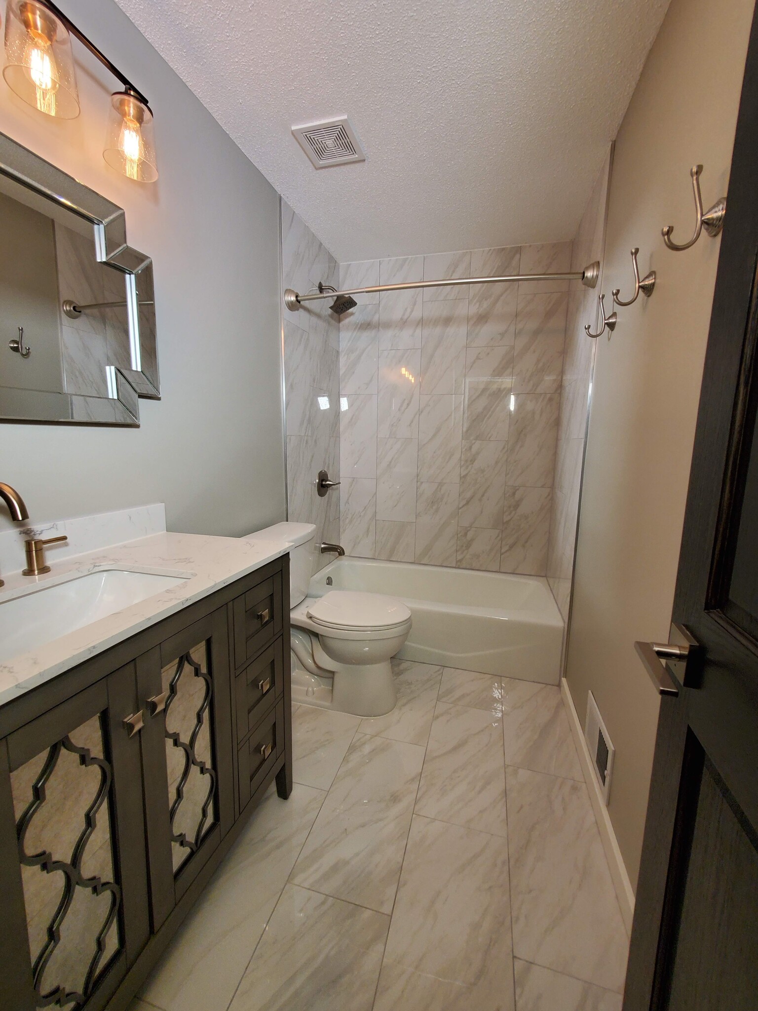 Bathroom has new tiled floors and shower surround. Brand new vanity, faucet, mirror, and light. - 2525 Cedar Hills Drive