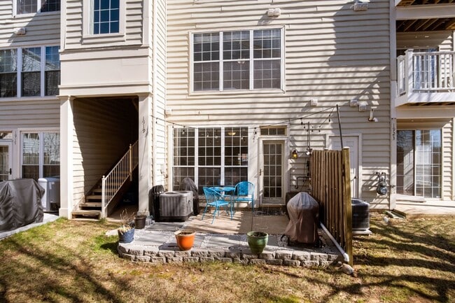 Building Photo - This inviting two-level townhome offers comfort and style, featuring gleaming hardwood floors on ...