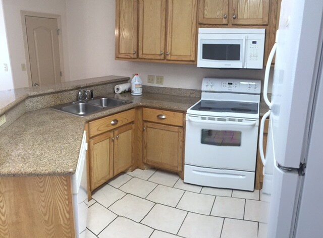 kitchen with microwave, oven and range, dishwasher and refrigerator. - 1503 West Fig Avenue