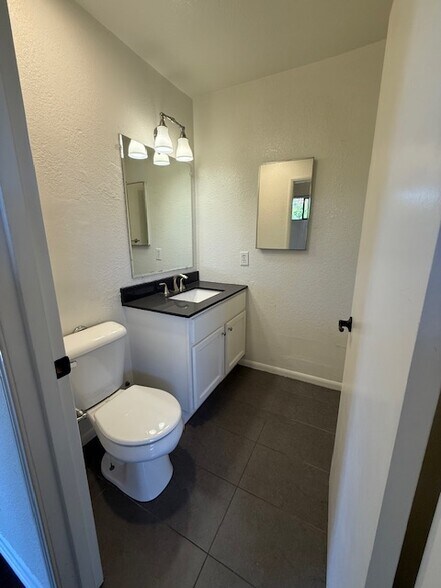 Powder room in hallway to large front bedroom - 10481 Riverside Dr