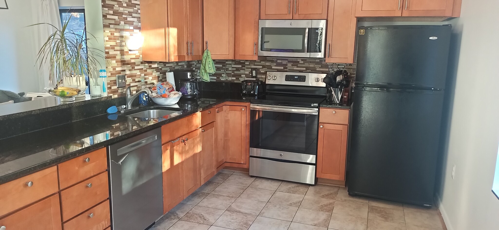 Sunny kitchen with direct access to living area and dining area. - 100 Roberts Ln