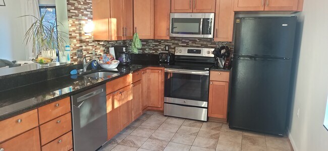 Sunny kitchen with direct access to living area and dining area. - 100 Roberts Ln