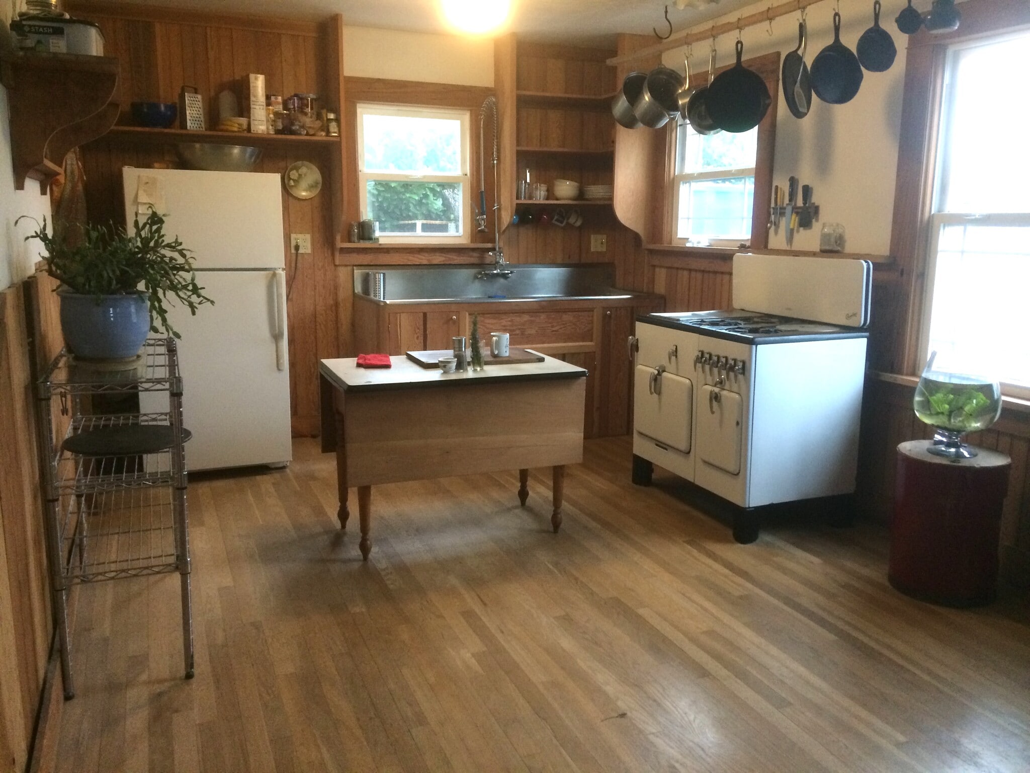 Bright kitchen with gas stove, custom pot rack, newer refrigerator, stainless steel sink, new plumbing. - 8950 NE Emerson St