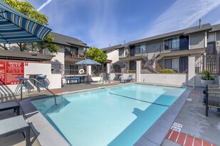 Dive into luxury living at Independence Plaza, where every day feels like a vacation with our refreshing swimming pool and stylish patio retreat adorned with cozy umbrellas. - Independence Plaza Apartment Homes