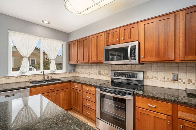 Building Photo - Spacious 4-Bedroom Home in District 20 with Huge Deck & Fenced Yard