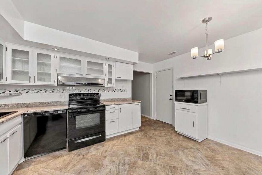 Beautiful, updated kitchen with glass front cabinets and tons of storage! All appliances - including range, refrigerator, dishwasher and microwave. Kitchen opens to Sunroom, charming patio and fully fenced back yard. - 11 Lawndale Ave