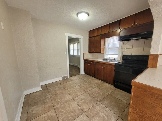 Building Photo - Four bedroom home on Indianola Ave with large yard and two decks!